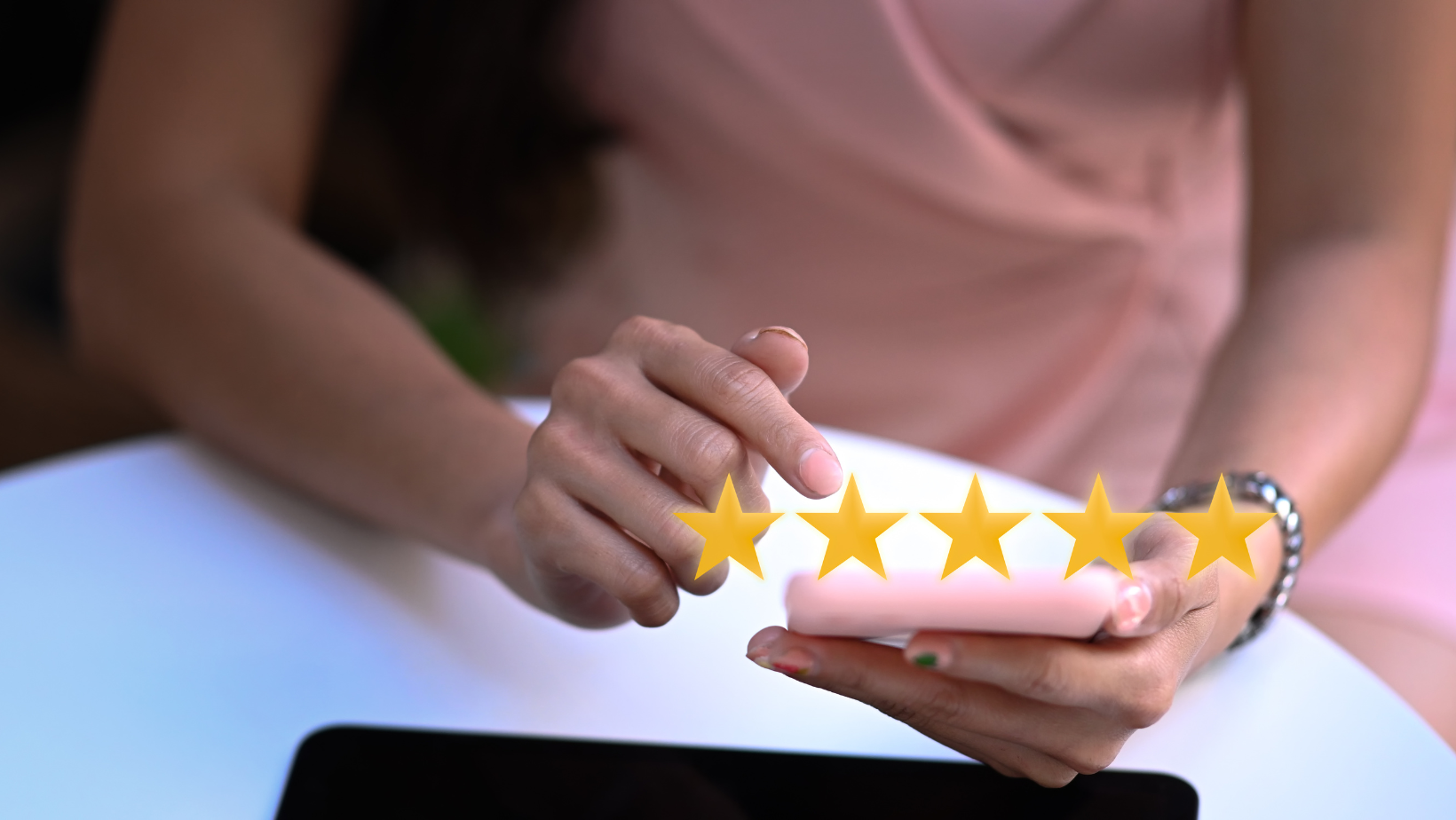 Woman using phone with five gold stars listed above the phone