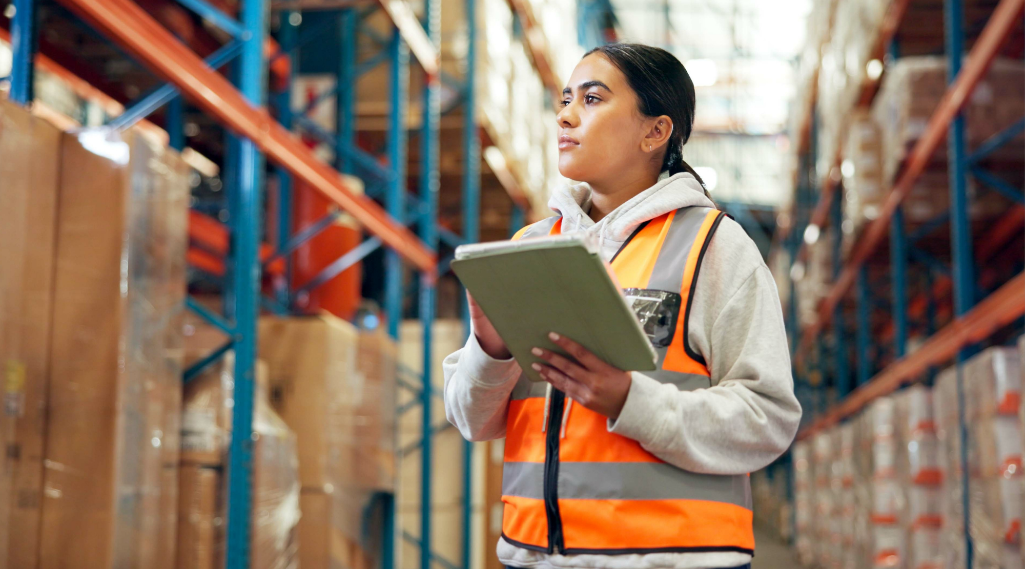 Woman in a warehouse with a clipboard